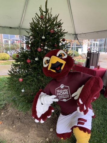 Freddie the Falcon poses for a photo with the 2020 FSU Christmas tree in the Falcon Center Quad.