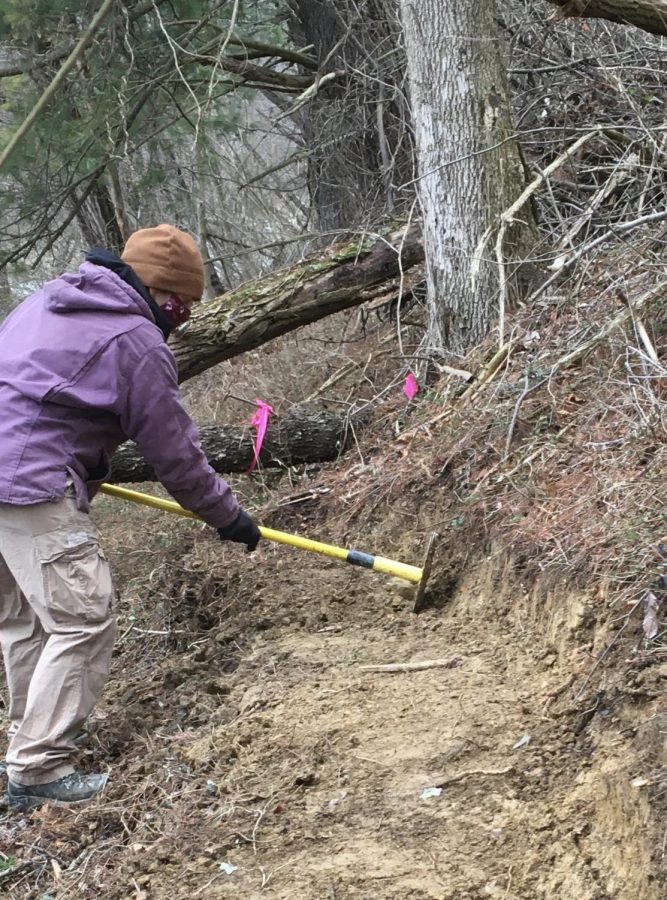 Laura Bennett, a Graduate Assistant and a student pursuing a Masters Degree in Exercise Science, working on the trail on the Fairmont State University campus.